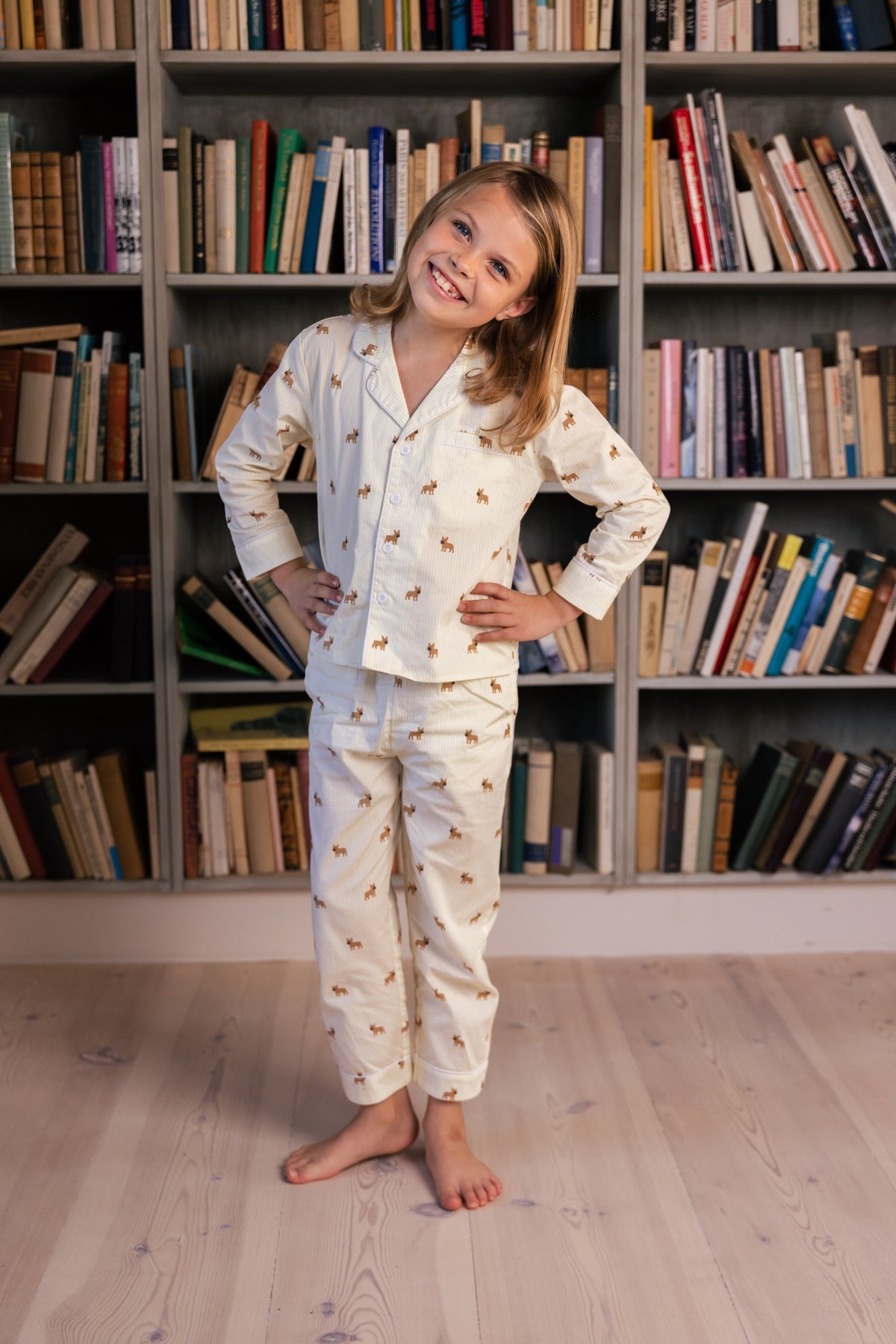 Child wearing the yellow and white Frenchie kids pajama