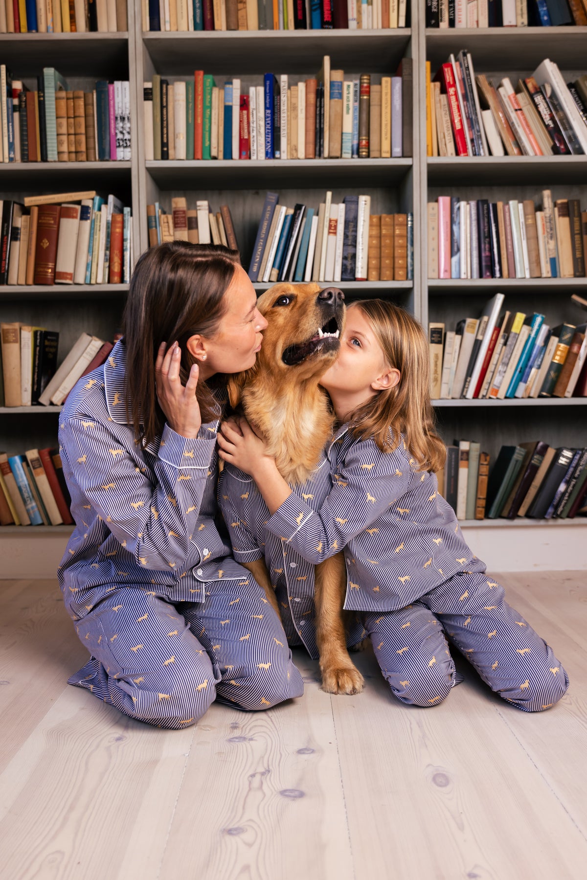 Family sharing a matching moment in navy and white Retriever pajamas