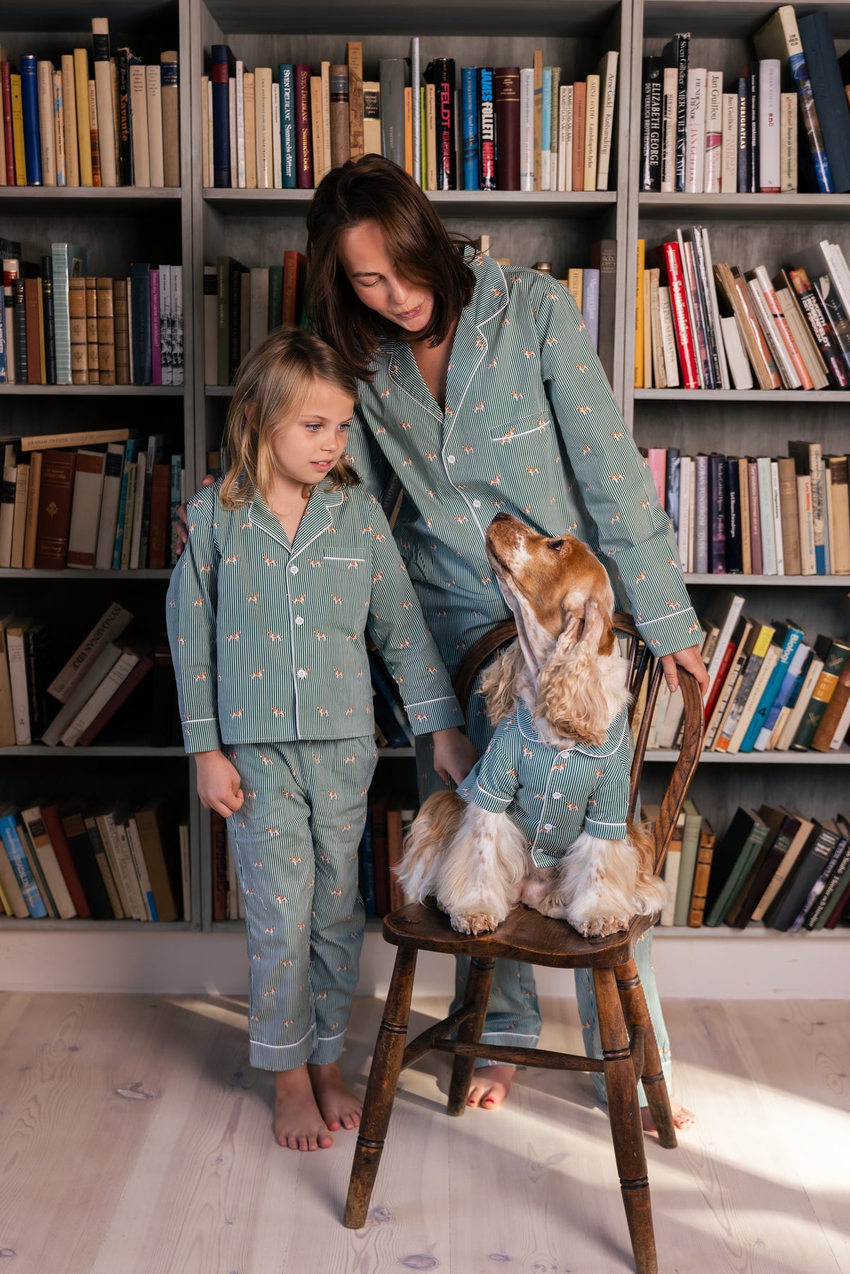Adult, child and Spaniel together in matching green and white pajamas