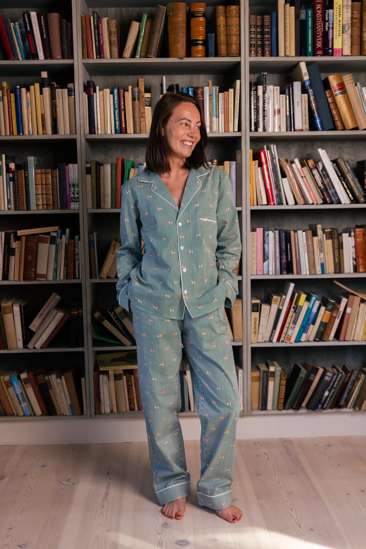 Adult standing in the green and white Spaniel unisex pajama set