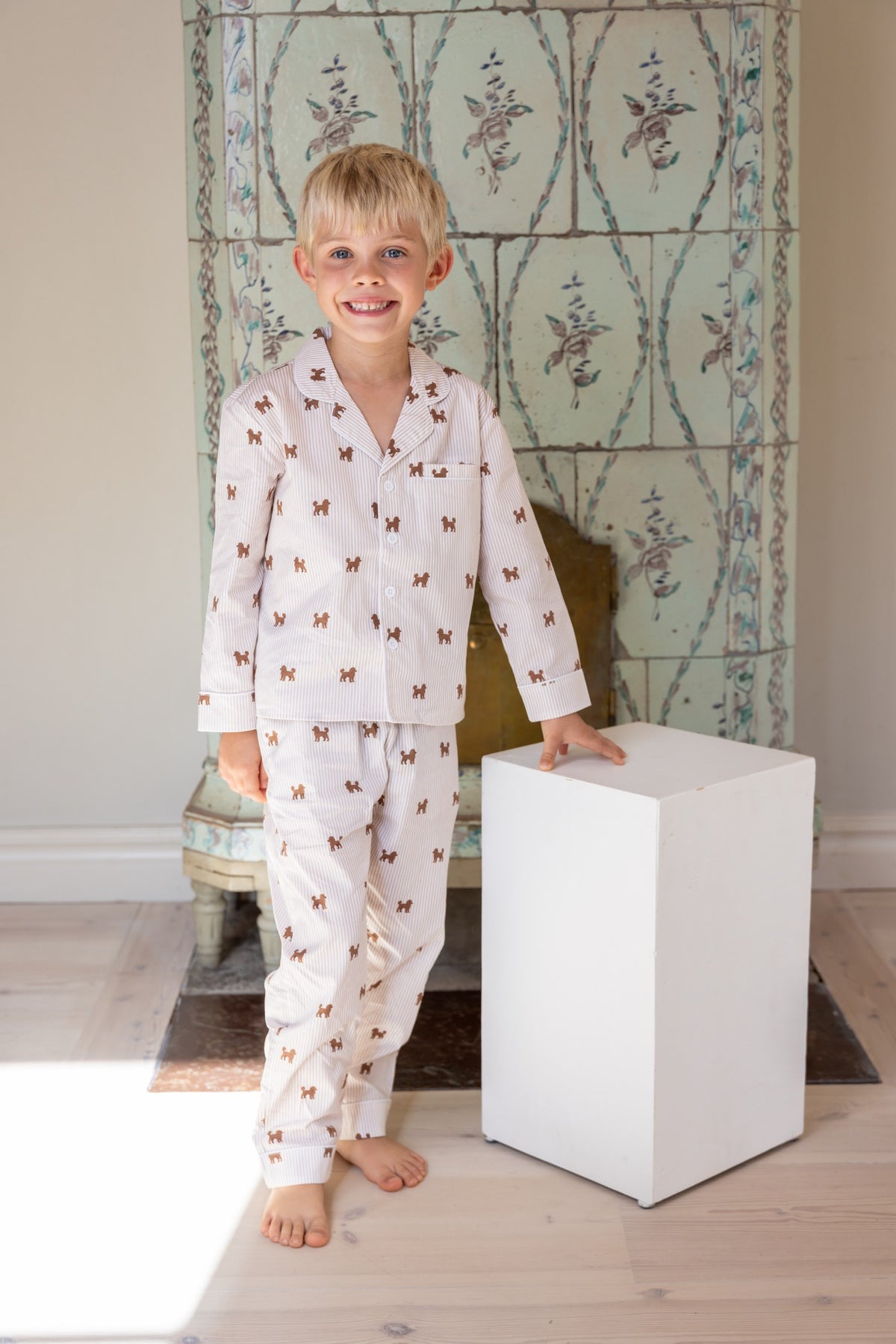 Child wearing the brown and white Doodle kids pajama