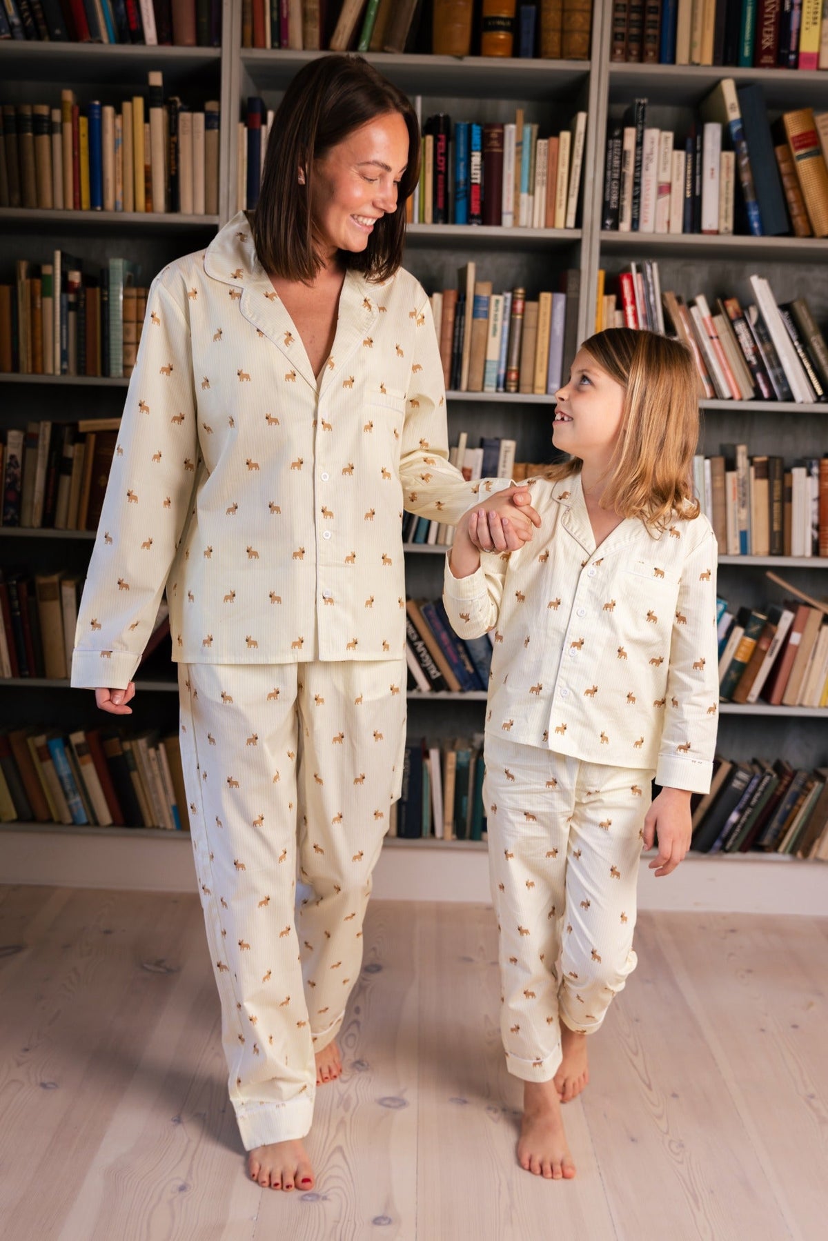 Adult and child wearing matching yellow and white Frenchie pajamas