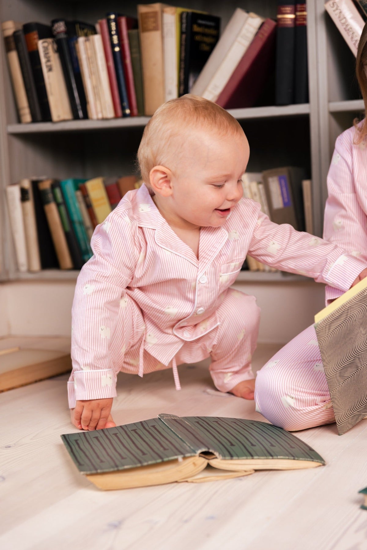 Child wearing the pink and white Pomeranian kids pajama