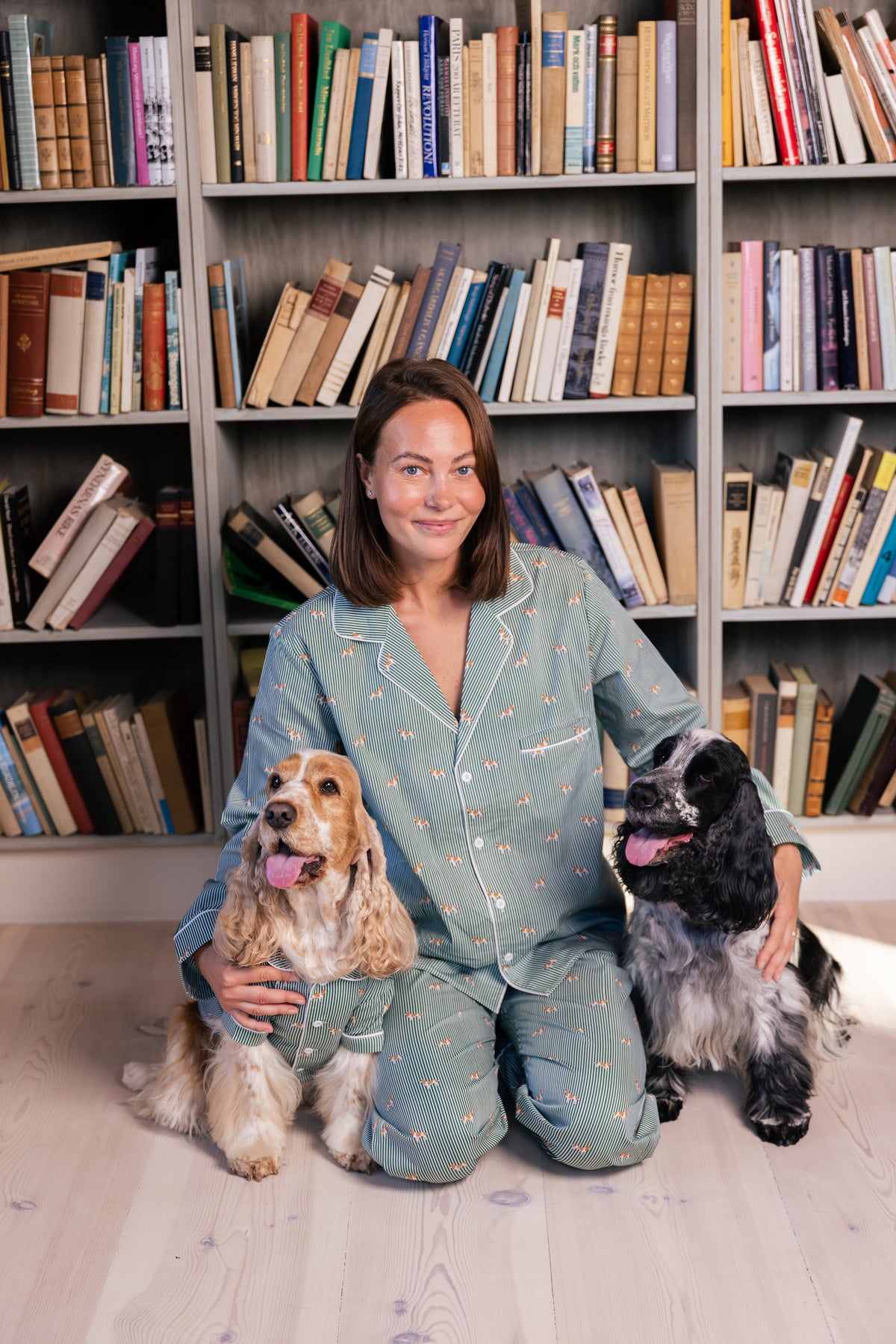 Adult with two Spaniels in the green and white matching pajama collection