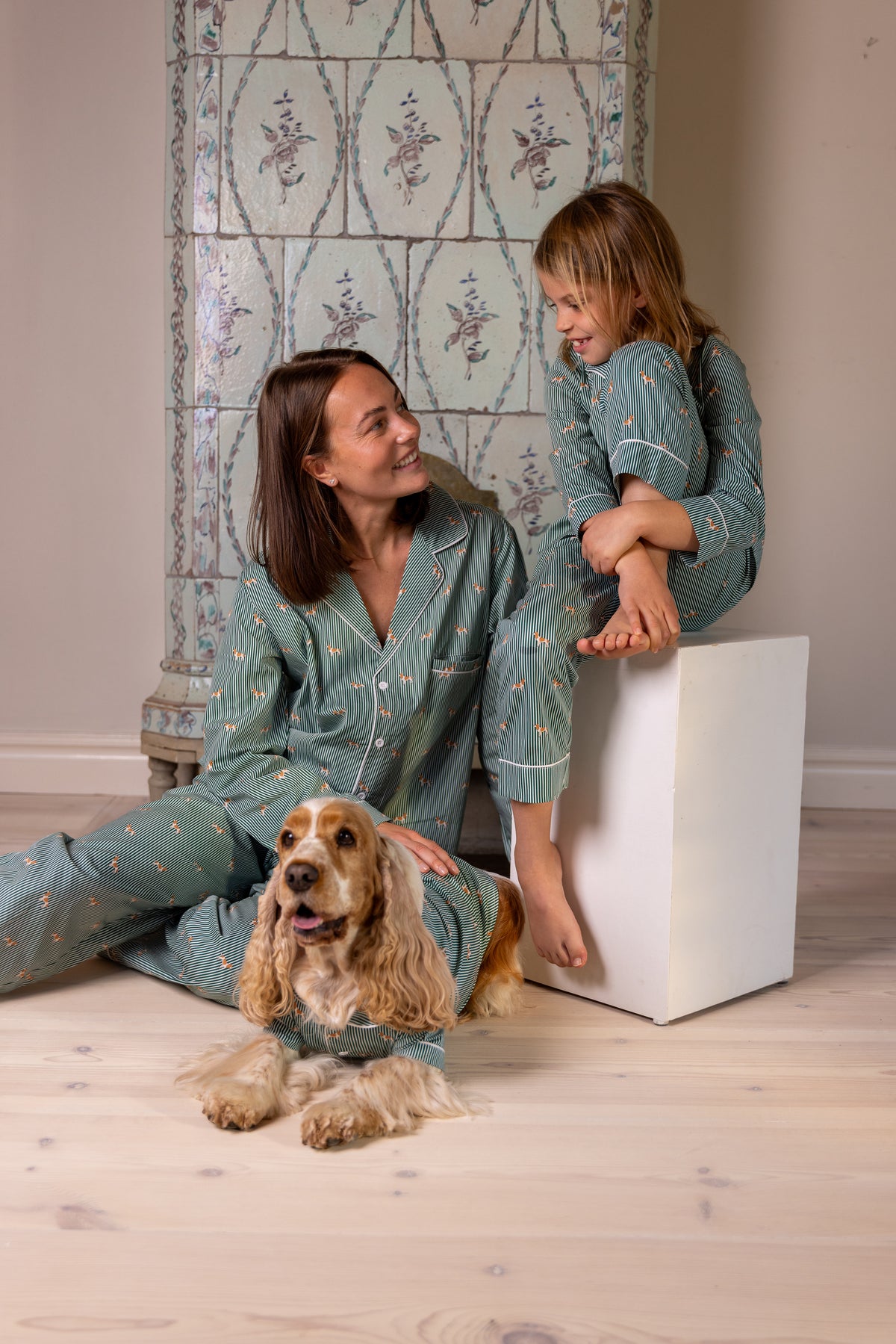 Adult, child and Spaniel sharing a relaxed matching moment